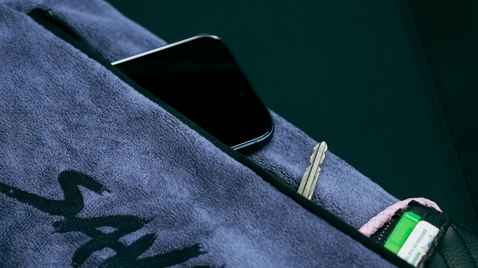 Savage towel with a phone showing the member app