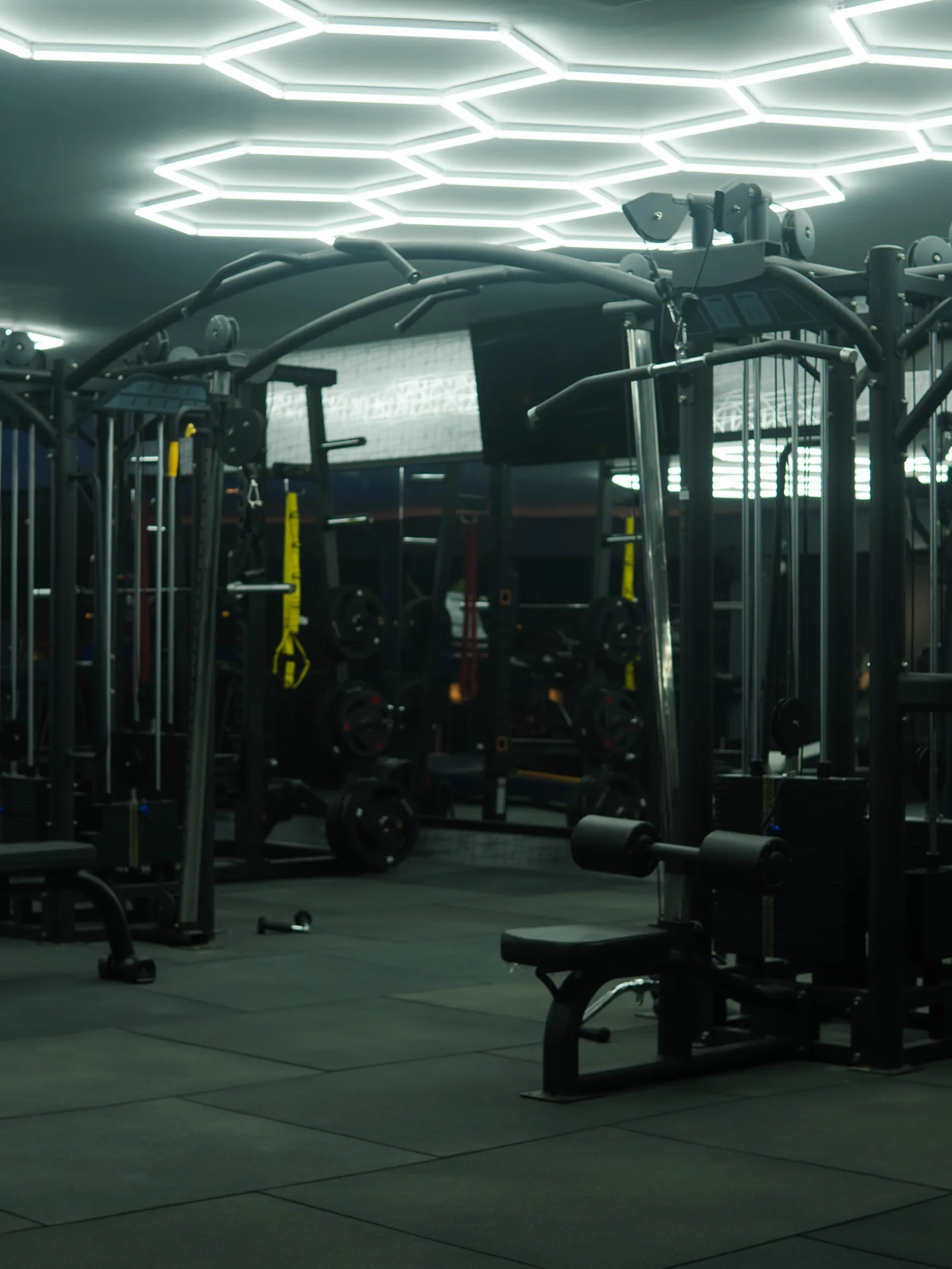 Savage Elite Fitness training floor under signature hexagon lighting